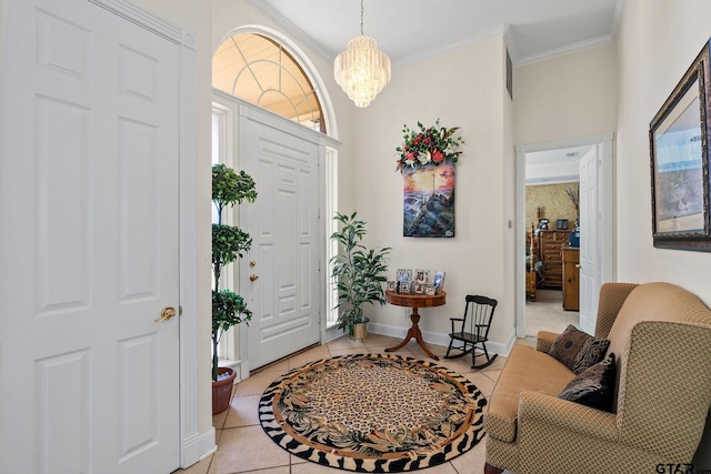 foyer featuring light tile patterned floors, a notable chandelier, crown molding, and baseboards