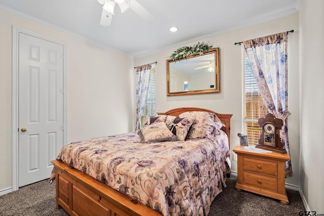 bedroom with crown molding, baseboards, dark colored carpet, and ceiling fan