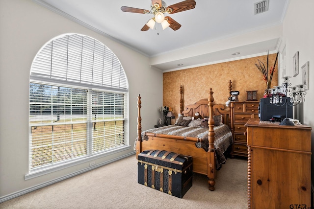 carpeted bedroom featuring ceiling fan, visible vents, ornamental molding, and wallpapered walls