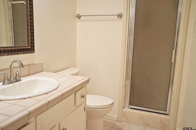 bathroom with vanity, toilet, tile patterned flooring, and walk in shower