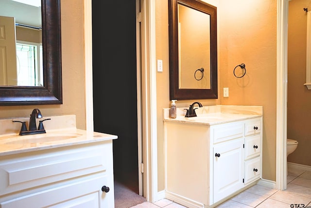 bathroom featuring toilet, vanity, and tile patterned floors