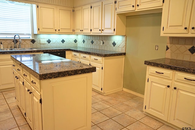 kitchen featuring a kitchen island, dark stone countertops, decorative backsplash, sink, and light tile patterned floors