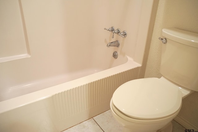 bathroom with toilet, tile patterned flooring, and tub / shower combination