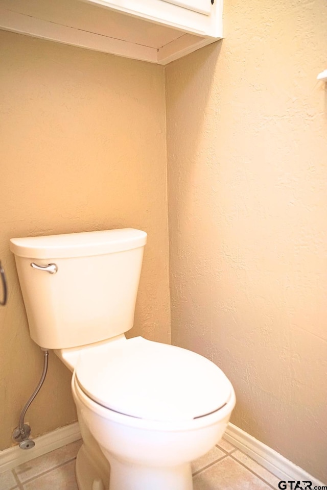 bathroom with tile patterned floors and toilet