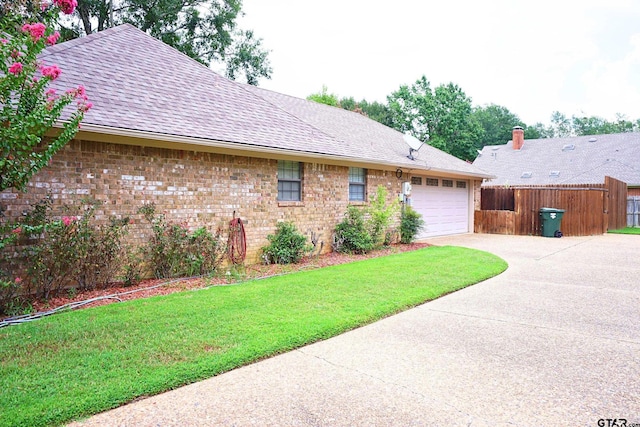 view of side of property with a garage and a yard