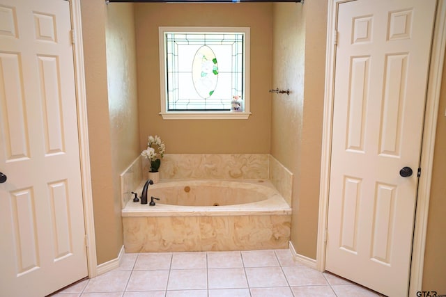 bathroom with tile patterned floors and tiled tub