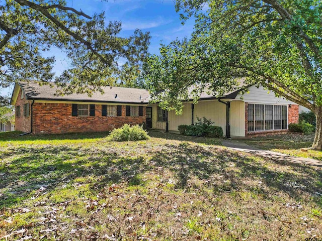 back of property featuring a lawn