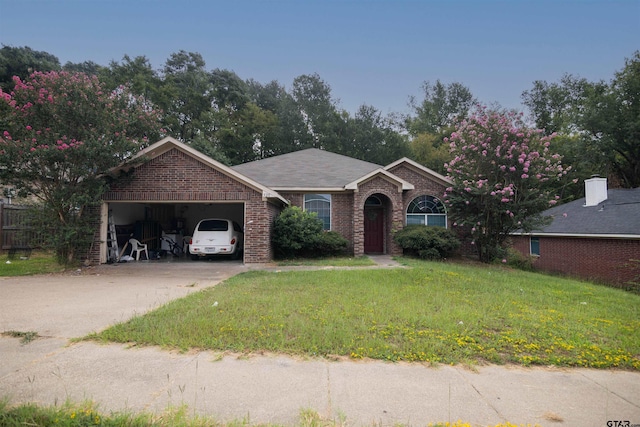 ranch-style house with a garage and a front lawn