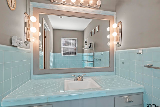 bathroom with vanity and tile walls