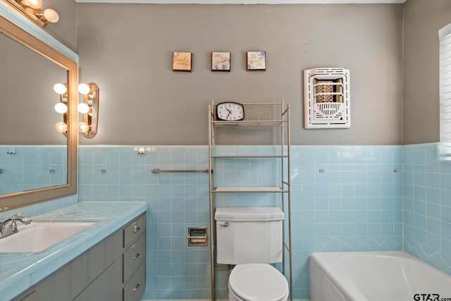 bathroom with toilet, vanity, tile walls, and a tub