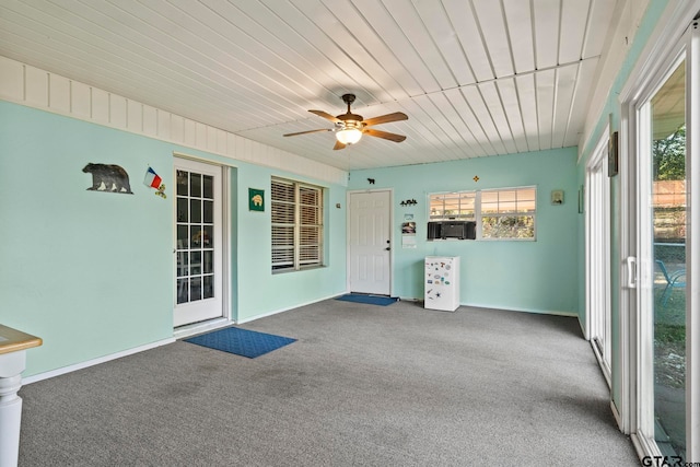 interior space with cooling unit, a healthy amount of sunlight, and ceiling fan