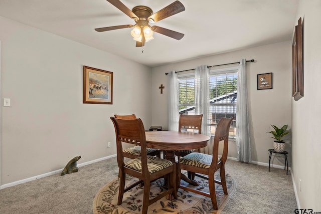 carpeted dining space featuring ceiling fan