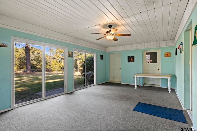 interior space featuring wooden ceiling, ceiling fan, and carpet