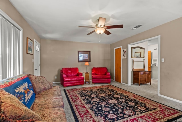 living room featuring a wealth of natural light, carpet floors, and ceiling fan