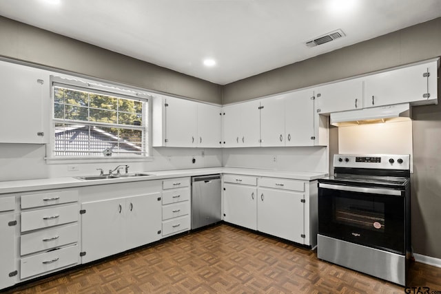 kitchen featuring white cabinetry, appliances with stainless steel finishes, sink, and dark parquet floors