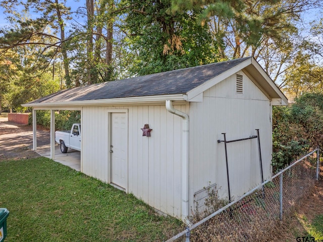 view of outbuilding featuring a lawn