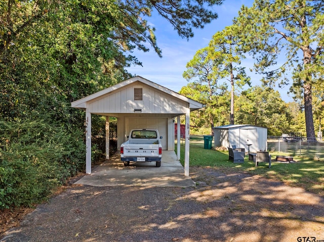 view of front of home with a front lawn, a storage unit, and a carport