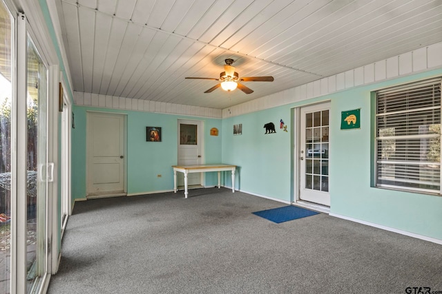 unfurnished sunroom with ceiling fan