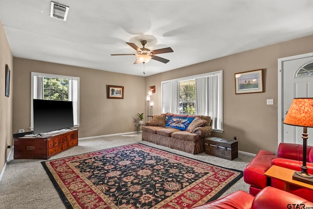 carpeted living room featuring ceiling fan