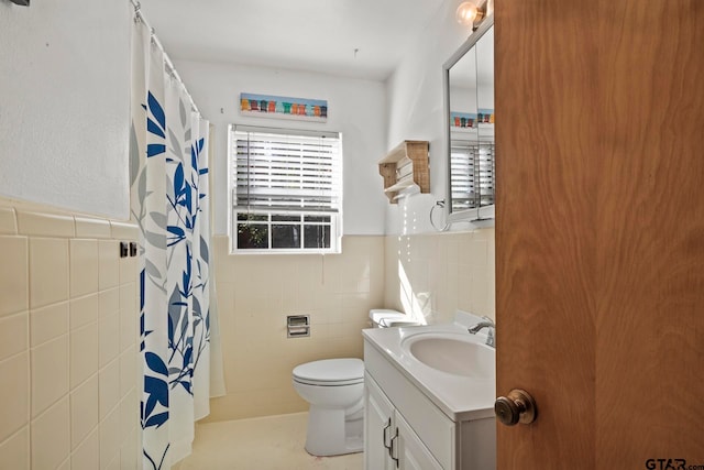 bathroom featuring toilet, vanity, tile walls, and a shower with shower curtain