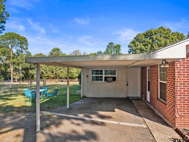 view of parking / parking lot with a lawn and a carport