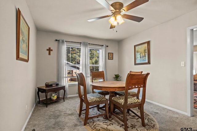 dining area with light colored carpet and ceiling fan