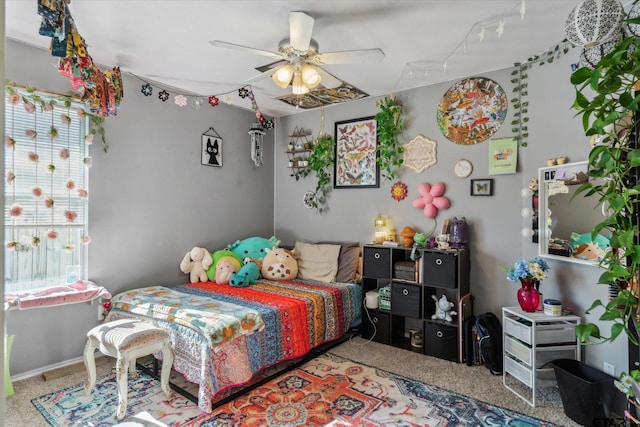 bedroom with track lighting, a ceiling fan, and carpet