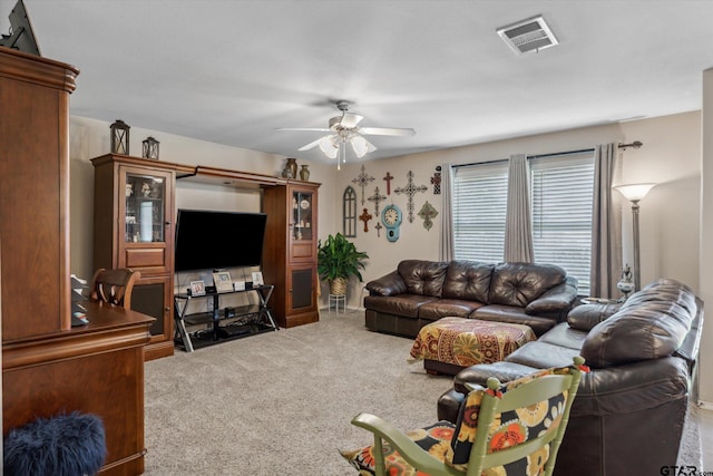 carpeted living room with ceiling fan and visible vents