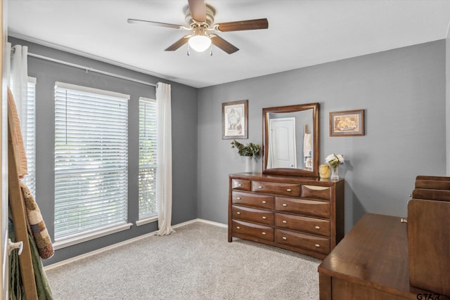 office area with baseboards, carpet, and a ceiling fan