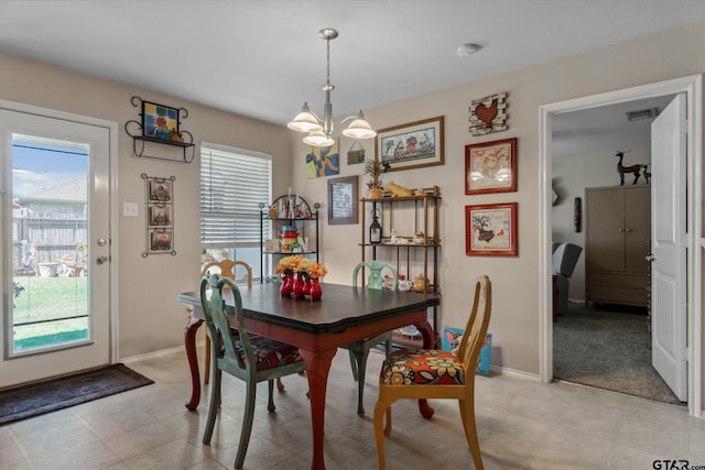 dining area with a healthy amount of sunlight, baseboards, visible vents, and a chandelier