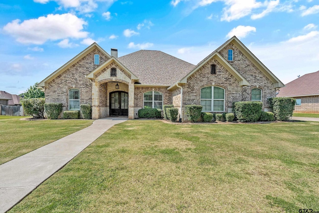 view of front of house with french doors and a front yard