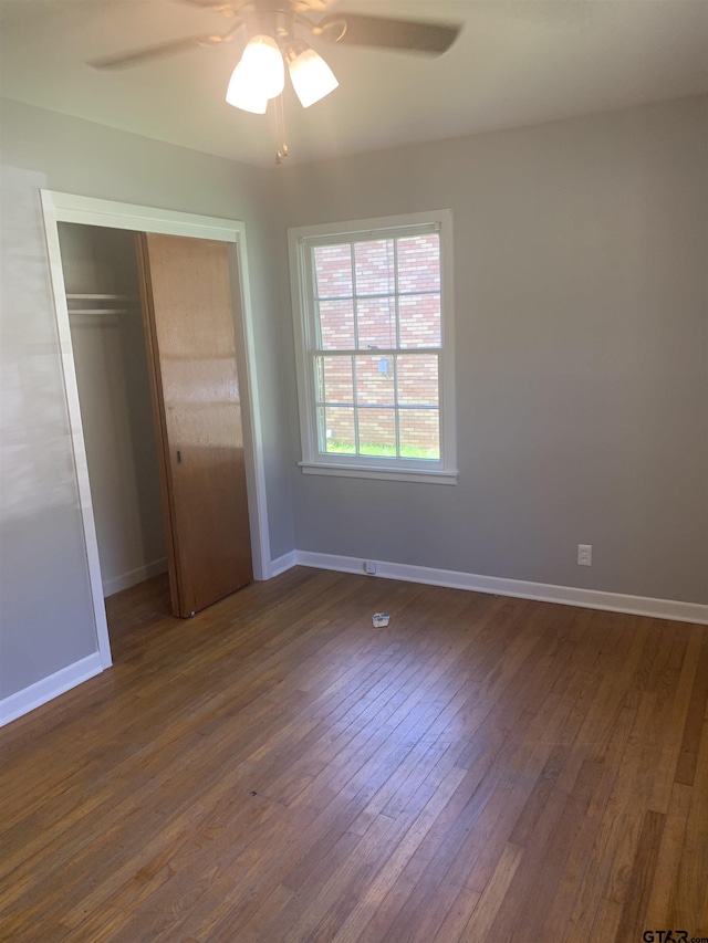 2326 Pleasant Dr, Tyler, TX 75701 - unfurnished bedroom featuring a closet, dark wood-style flooring, and a ceiling fan