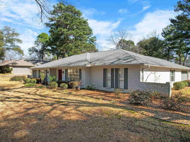 ranch-style home with a front lawn