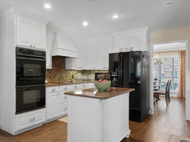 kitchen featuring dark wood-type flooring, custom exhaust hood, white cabinetry, a kitchen island, and black appliances