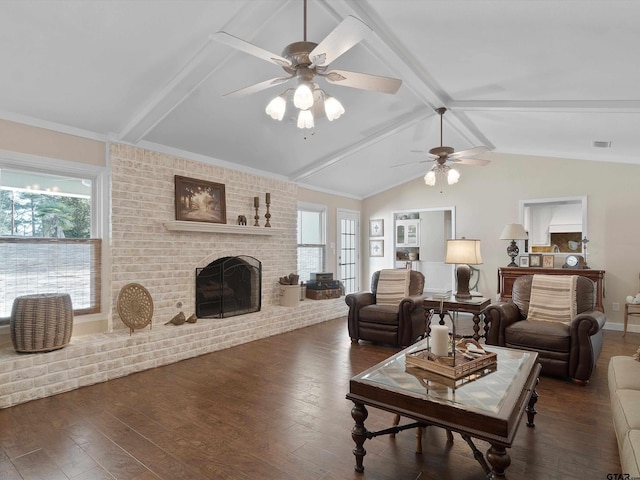 living room featuring dark hardwood / wood-style flooring, a brick fireplace, and a healthy amount of sunlight