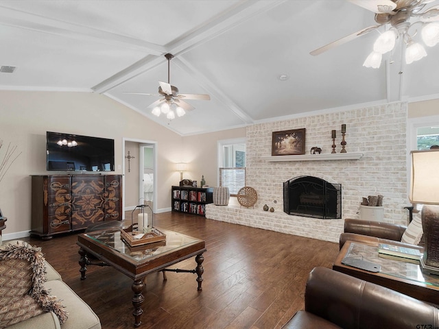 living room with lofted ceiling with beams, dark hardwood / wood-style floors, ceiling fan, brick wall, and a fireplace