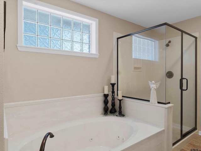 bathroom featuring shower with separate bathtub