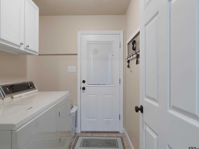 washroom featuring washer and clothes dryer and cabinets