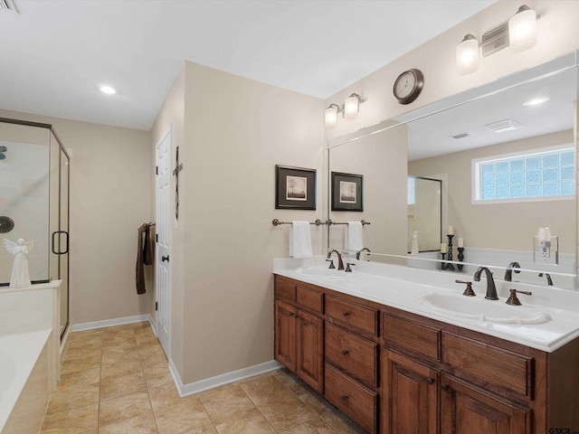 bathroom featuring tile patterned floors, vanity, and shower with separate bathtub