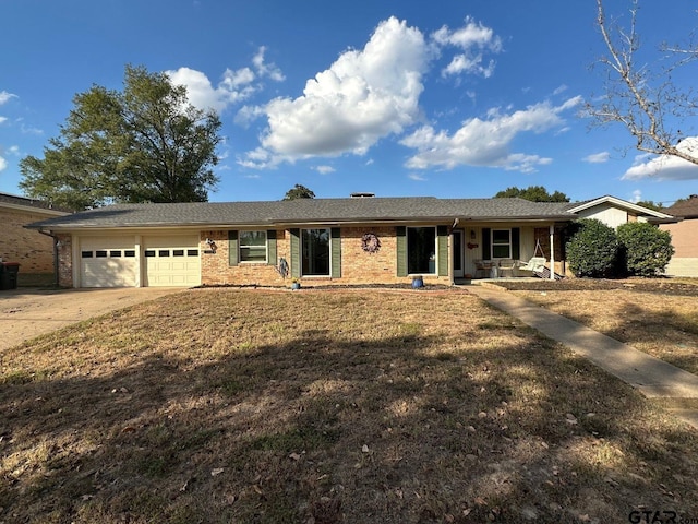 single story home with a front yard, a porch, and a garage