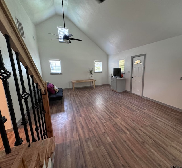 unfurnished living room featuring hardwood / wood-style floors, a wealth of natural light, ceiling fan, and high vaulted ceiling