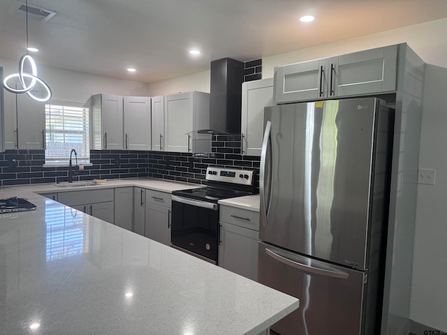 kitchen with gray cabinets, appliances with stainless steel finishes, sink, and wall chimney range hood