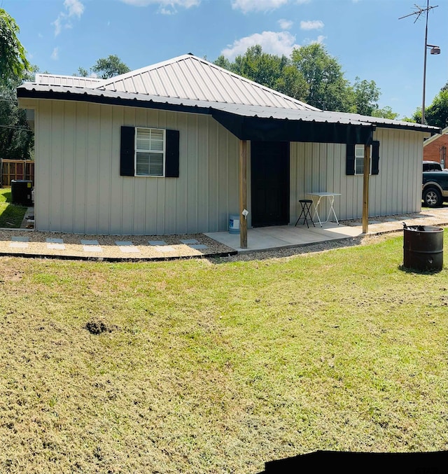 back of property featuring a lawn and a patio area