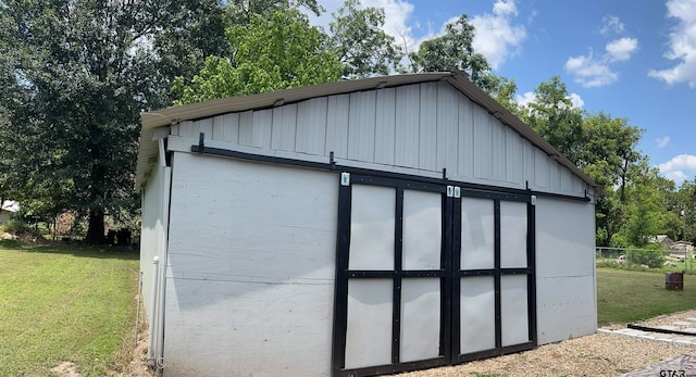 view of outbuilding with a lawn