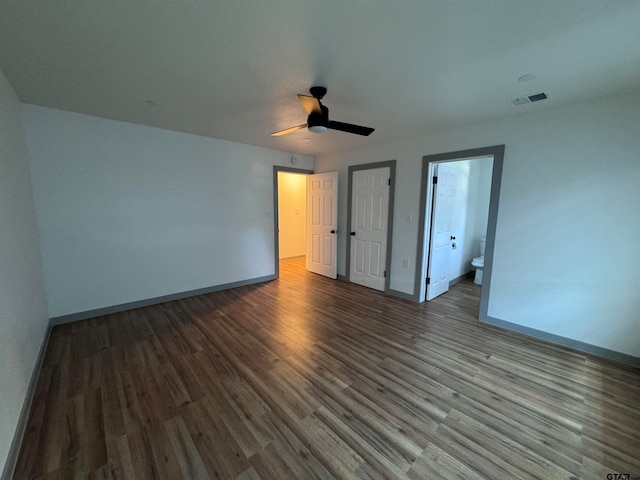 unfurnished bedroom with hardwood / wood-style flooring, ensuite bath, and ceiling fan