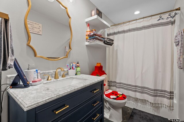 bathroom featuring a shower with curtain, tile patterned flooring, vanity, and toilet