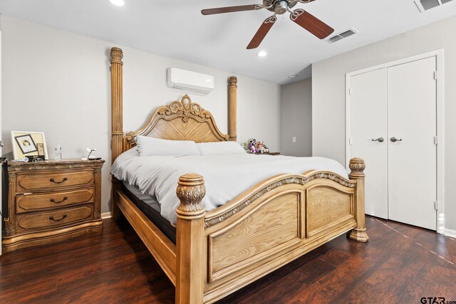 bedroom with a wall mounted air conditioner, a closet, ceiling fan, and dark wood-type flooring