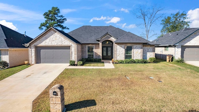 french country style house with a garage, french doors, and a front lawn