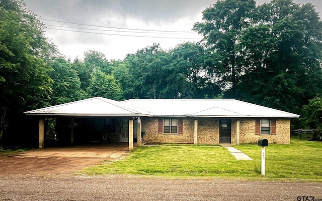 single story home featuring a front yard, concrete driveway, and an attached carport