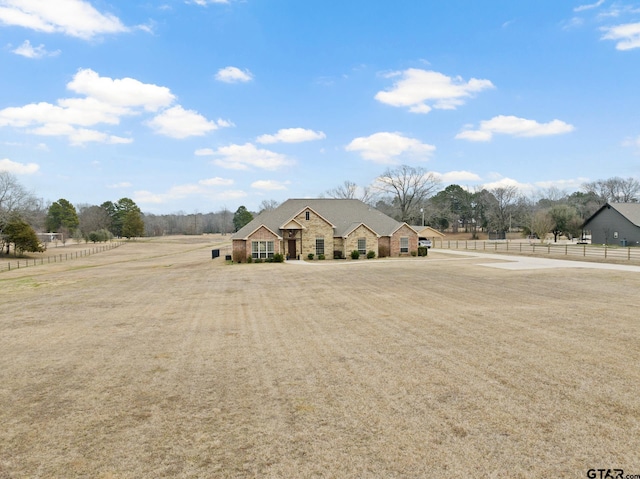 view of front of home with a rural view